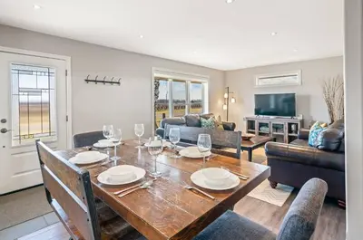a dining room with a table with wine glasses at Single Level Vineyard Home | 6 PPL | Pet Friendly in Niagara on the Lake