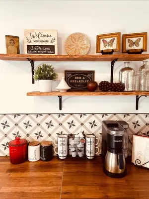 a kitchen with shelves and a coffee maker on a wooden floor at Top 5% Sauna | Bocce Ball | Vineyard Views | NOTL in Niagara on the Lake