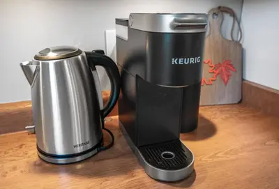 a coffee maker and a kettle on a table at Vineyard Home Pet Friendly NOTL Large Backyard in Niagara on the Lake