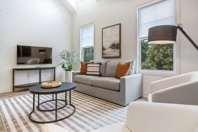 a living room with a couch and a table at 1 Bdrm Luxe Apartment in Niagara in Niagara on the Lake