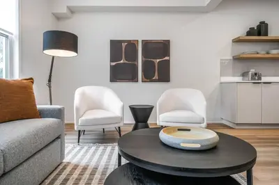 a living room with a couch and two chairs and a table at 1 Bdrm Luxe Apartment in Niagara in Niagara on the Lake