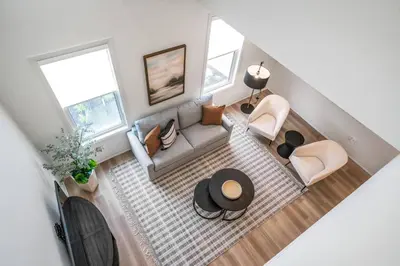 an overhead view of a living room with a couch and chairs at 1 Bdrm Luxe Apartment in Niagara in Niagara on the Lake