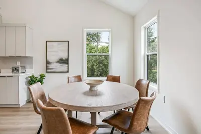 a kitchen and dining room with a table and chairs at 2 Bdrm Brand New Luxe Niagara Apt - up to 6ppl in Niagara on the Lake