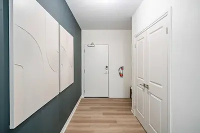 a hallway with white walls and a white door at 2 Bdrm Brand New Luxe Niagara Apt - up to 6ppl in Niagara on the Lake