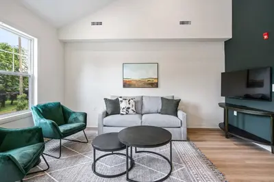 a living room with a couch and a table and chairs at 2 Bdrm Brand New Luxe Niagara Apt - up to 6ppl in Niagara on the Lake