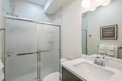 a bathroom with a shower and a sink at 2 Bdrm Brand New Luxe Niagara Apt - up to 6ppl in Niagara on the Lake