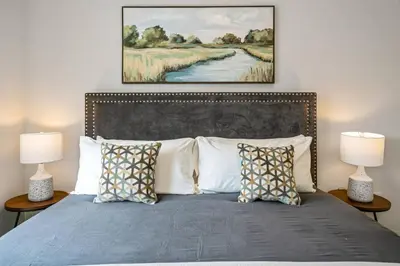 a bedroom with a bed with two lamps at 2 Brdm Modern Brand New Niagara Apt up to 6 ppl in Niagara on the Lake