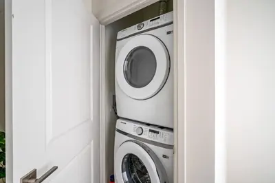 a laundry room with a washer and dryer at 2 Bdrm New Stylish Apt for up to 6 ppl in Niagara in Niagara on the Lake