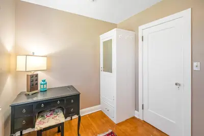 a room with a table with a lamp and a door at Walk to Old Town | Cottage 3 ppl Top 10% | Parking in Niagara on the Lake