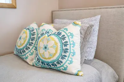 a group of pillows sitting on a chair at Walk to Old Town | Cottage 3 ppl Top 10% | Parking in Niagara on the Lake