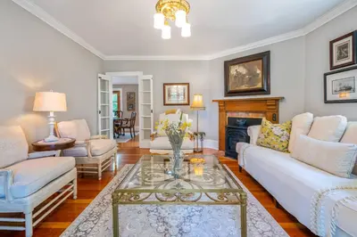 a living room with white furniture and a fireplace at Hot Tub | Mini Putt | Historic Old Town | 2 Guests in Niagara on the Lake