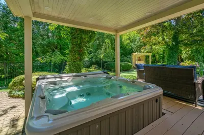 a jacuzzi tub sitting on a patio at Hot Tub | Mini Putt | Historic Old Town | 2 Guests in Niagara on the Lake