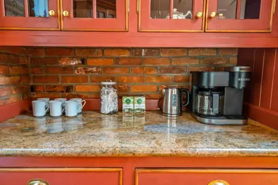 a counter top with a coffee maker and cups on it at Hot Tub | Mini Putt | Historic Old Town | 2 Guests in Niagara on the Lake