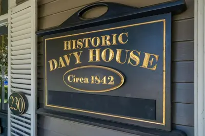 a sign for ahistoric day house on the side of a building at Hot Tub | Historic Home | Steps to Everything NOTL in Niagara on the Lake