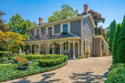 an old house with a brick driveway at Hot Tub | Historic Home | Steps to Everything NOTL in Niagara on the Lake