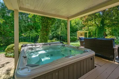 a jacuzzi tub sitting on a patio at Hot Tub | Heart of Old Town NOTL | 2 Guests in Niagara on the Lake