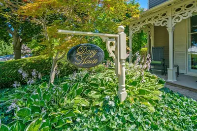 a sign in a garden in front of a house at Hot Tub | Heart of Old Town NOTL | 2 Guests in Niagara on the Lake