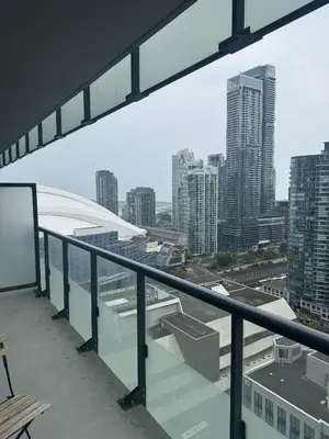 a balcony with a view of a city at Lush 3 Bedroom Condo by CN Tower - Free Parking in Toronto