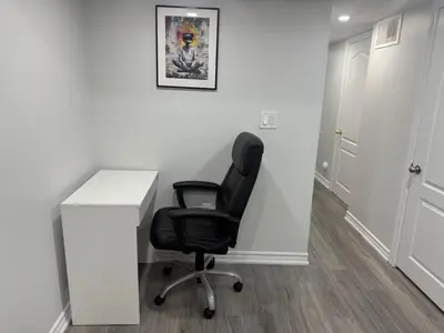 a black office chair sitting next to a white desk at Cozy Private Two-Level Suite In Brampton With Separate Entrance And Living Area on Main Floor in Brampton