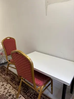 two chairs and a white table in a room at park inn in Toronto