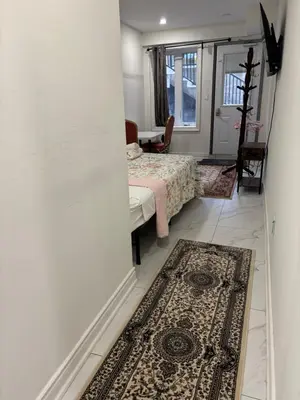 a bedroom with a bed and a rug on the floor at park inn in Toronto