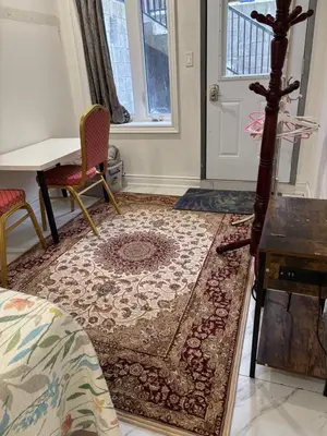a room with a rug and a table and a door at park inn in Toronto