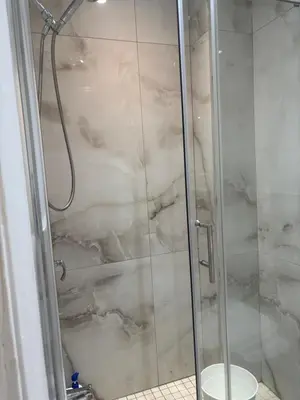 a shower with a glass door and a toilet at park inn in Toronto
