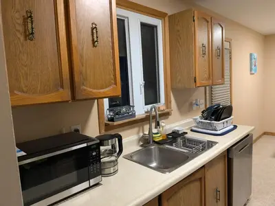 a kitchen with a sink and a microwave at Cozy Belleville Retreat Near DT & Waterfront in Belleville
