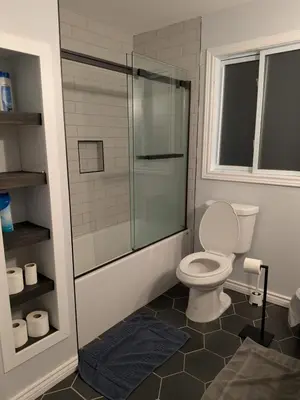a bathroom with a toilet and a glass shower at Cozy Belleville Retreat Near DT & Waterfront in Belleville