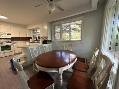 a kitchen with a dining room table and chairs at Modern Private Room with Bessarion Subway North York in Toronto