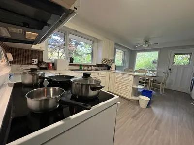 a kitchen with pots and pans on a stove at Modern Private Room with Bessarion Subway North York in Toronto