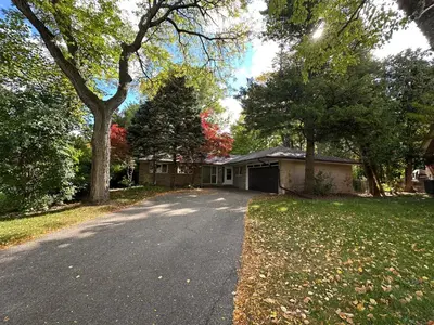 a house with a driveway in front of a house at Modern Private Room with Bessarion Subway North York in Toronto