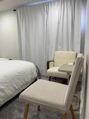 a bedroom with a bed and a table and chairs at Rayann Hospitality in Toronto