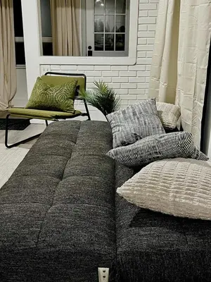 a couch with pillows and a chair in a living room at Etobicoke Escape in Toronto