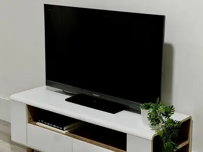 a flat screen tv sitting on a white entertainment center at Etobicoke Escape in Toronto