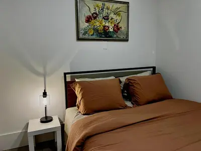 a bedroom with a bed and a painting on the wall at Etobicoke Escape in Toronto