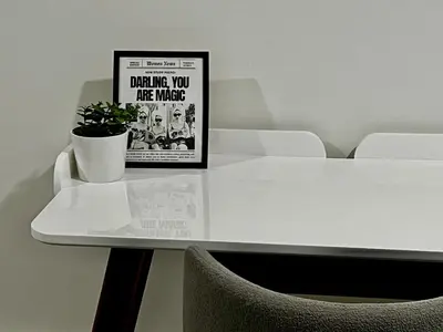 a white table with a poster and a plant on it at Etobicoke Escape in Toronto