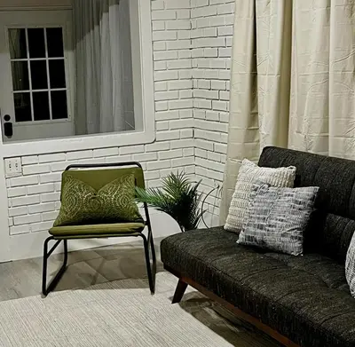 a couch and a chair in a living room at Etobicoke Escape in Toronto