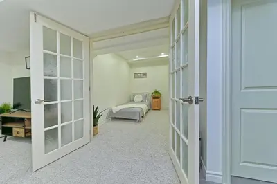 an open door to a room with a bedroom at SPACIOUS & FULLY PVT-2BR UNIT ON GROUND LEVEl in Burlington