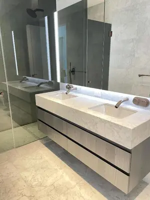 a bathroom with two sinks and a mirror at Deluxe Suites Downtown Toronto in Toronto