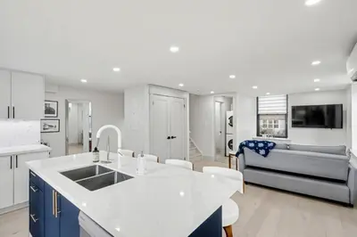 a kitchen and living room with a sink and a couch at The Wynford Dreamy Capri Suite in Elora