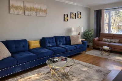 a living room with a blue couch and a table at 4-Bed, 3 bath Luxury Home in Oakville - Prime location in Oakville