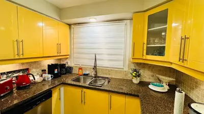 a kitchen with yellow cabinets and a sink at 4-Bed, 3 bath Luxury Home in Oakville - Prime location in Oakville