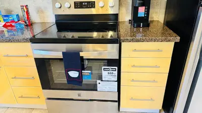 a kitchen with a black and stainless steel oven at 4-Bed, 3 bath Luxury Home in Oakville - Prime location in Oakville