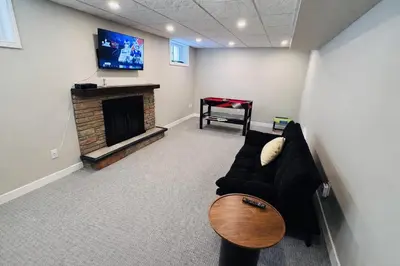 a living room with a couch and a fireplace at 4-Bed, 3 bath Luxury Home in Oakville - Prime location in Oakville