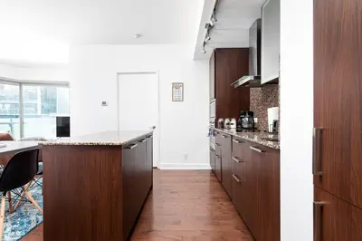 a kitchen with wooden cabinets and a counter top at 2 bedrooms Downtown Toronto Free parking in Toronto