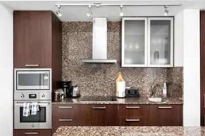 a kitchen with brown cabinets and a counter top at 2 bedrooms Downtown Toronto Free parking in Toronto