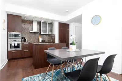 a kitchen with a table and chairs in a room at 2 bedrooms Downtown Toronto Free parking in Toronto