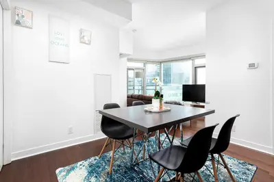 a dining room with a table and chairs at 2 bedrooms Downtown Toronto Free parking in Toronto