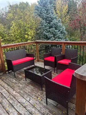a deck with chairs and tables and a fire pit at Cozy Home Away From Home in Kitchener